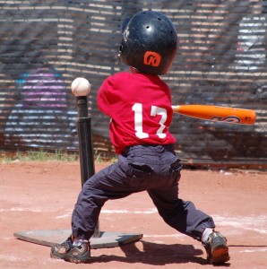 Tee_ball_player_swinging_at_ball_on_tee_2010